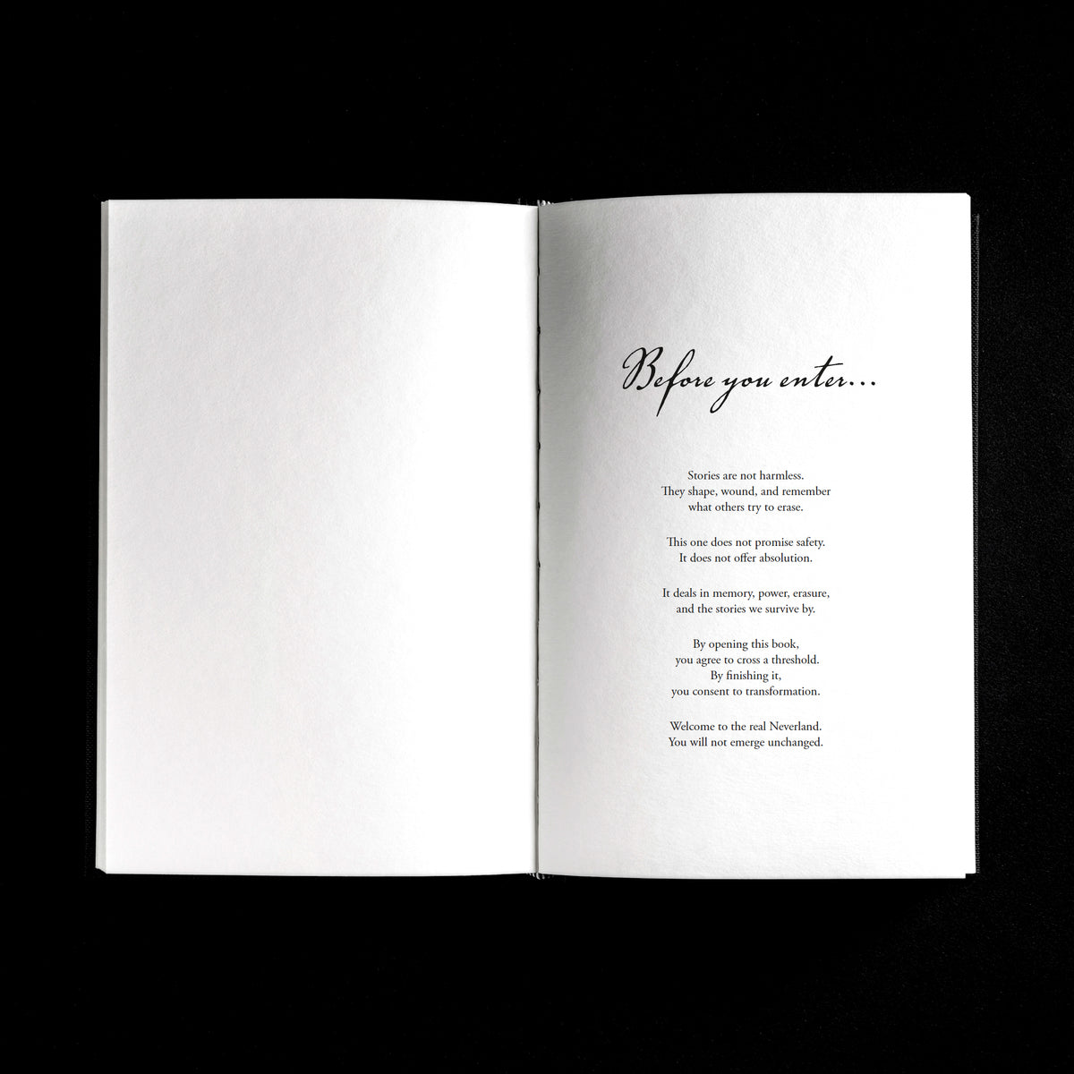 An open book laid flat against a solid black background, showing a white interior spread with the heading 'Before you enter.'
